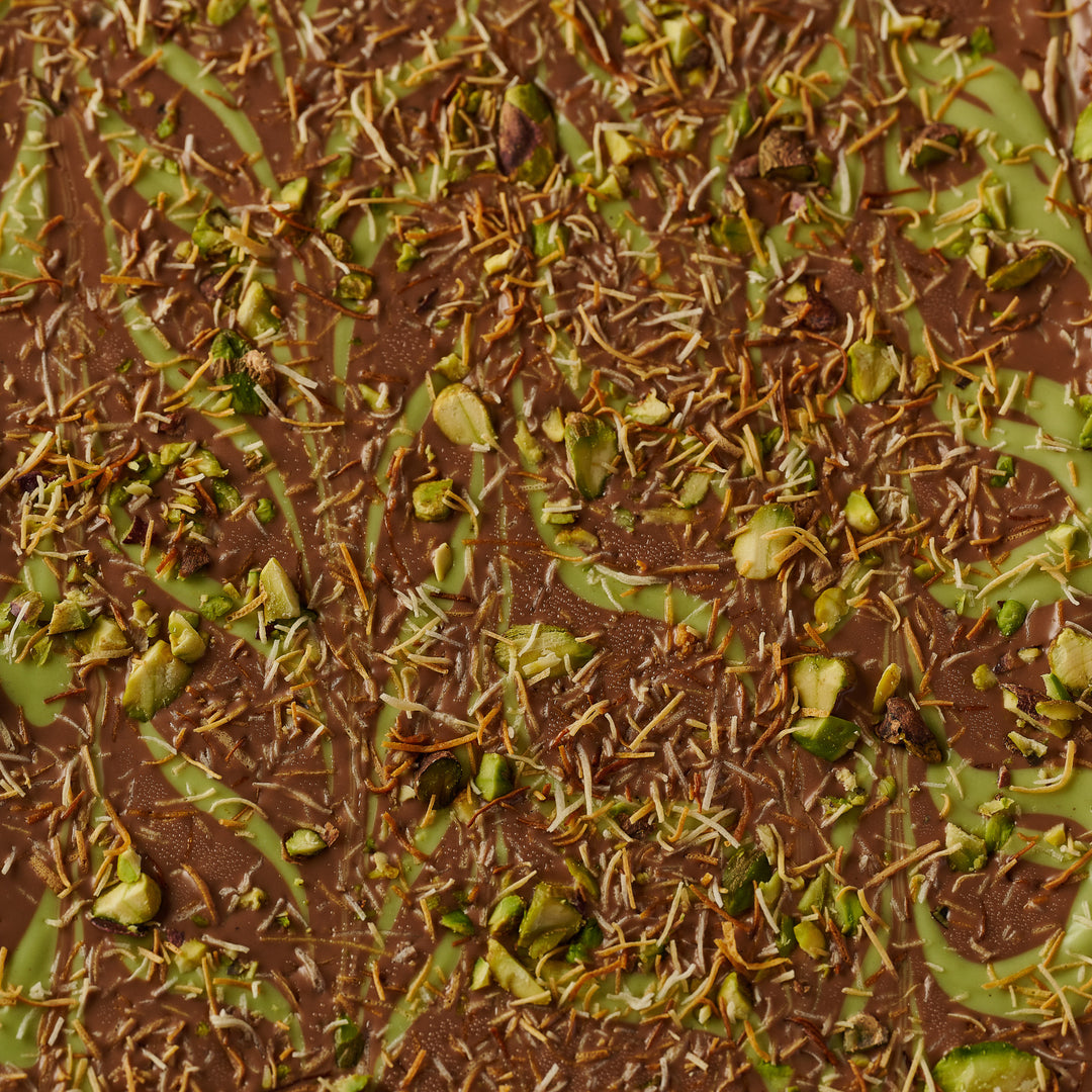 Artisan Pistachio Brownie with Creamy Pistachio Swirl and Chocolate Topping sprinkled with kunafa