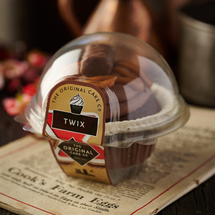 Six chocolate cupcakes topped with rich frosting, caramel, and Twix chunks