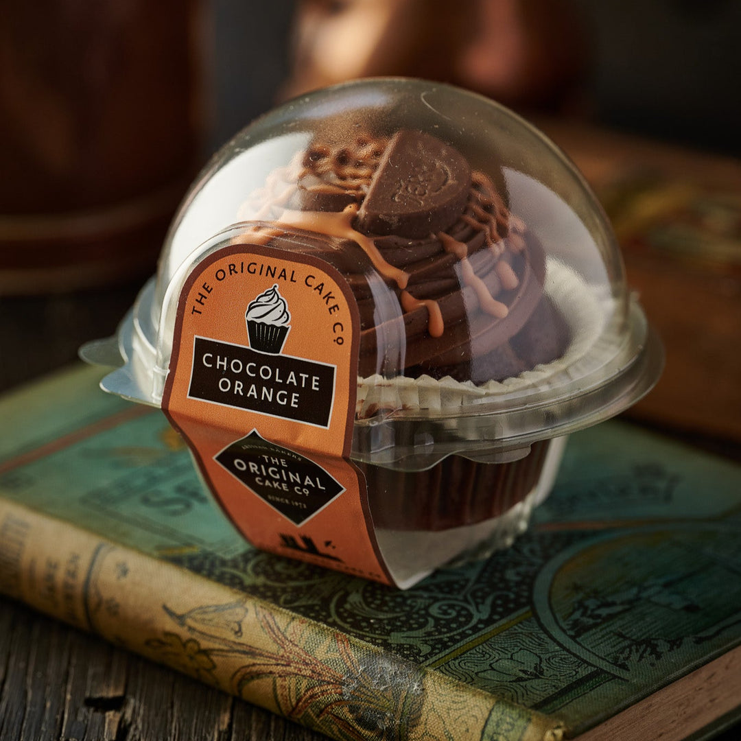 Cafe Range Chocolate and orange cupcakes topped with swirls of chocolate frosting and orange zest.