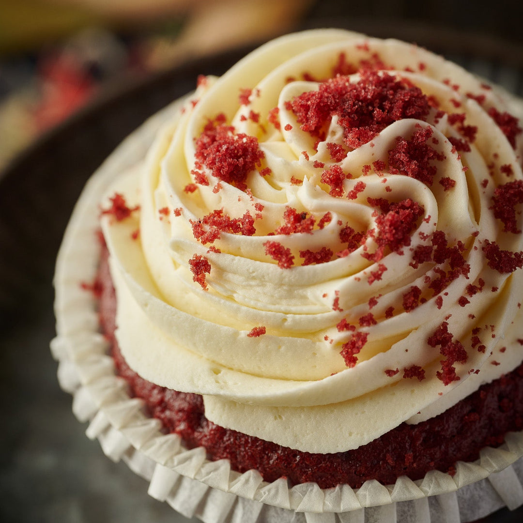 Individually wrapped red velvet cupcakes with classic sponge and creamy frosting, designed for café menus.