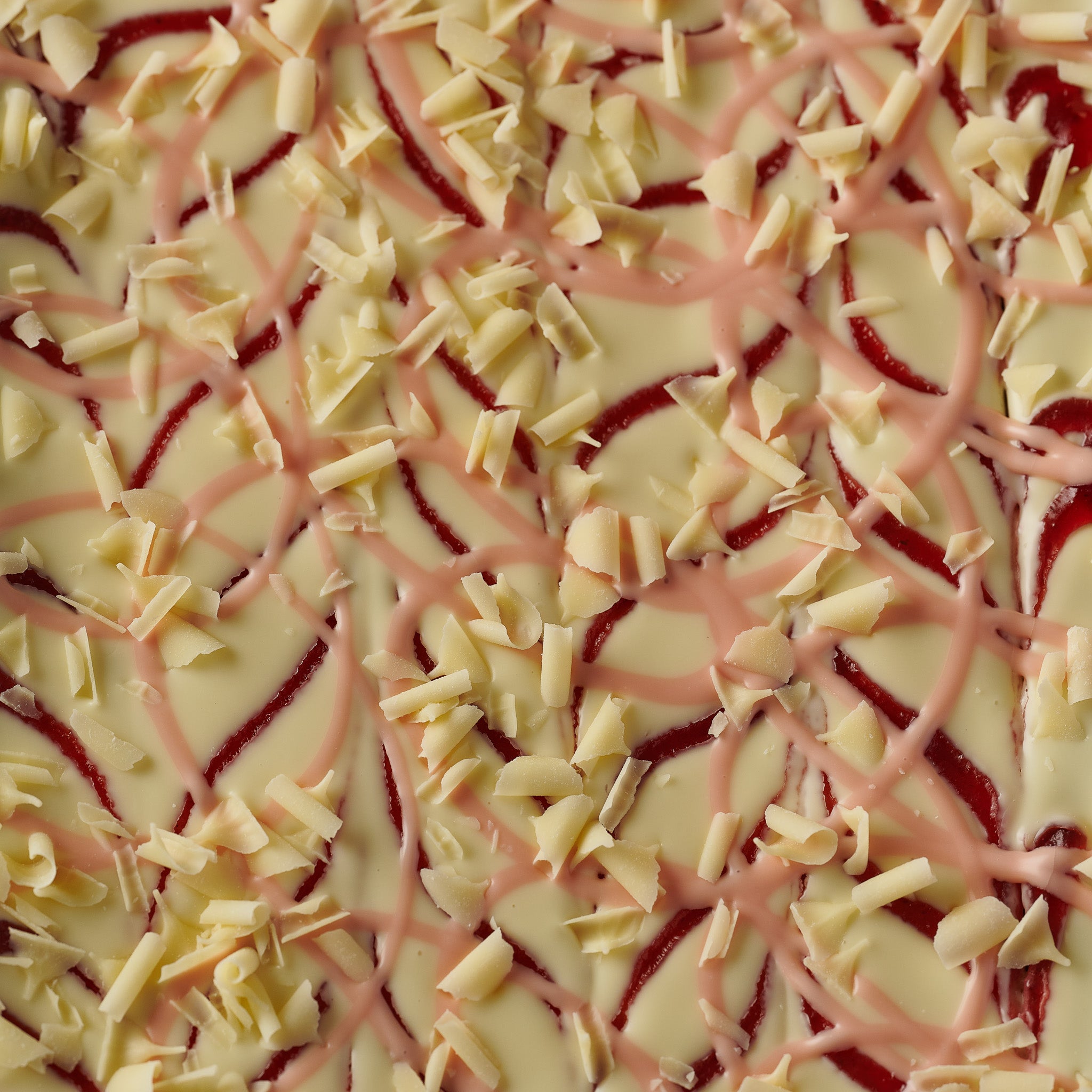 Delicious strawberry and white chocolate brownie showcasing a moist and rich consistency, accented by strawberry jam and  white chocolate curls